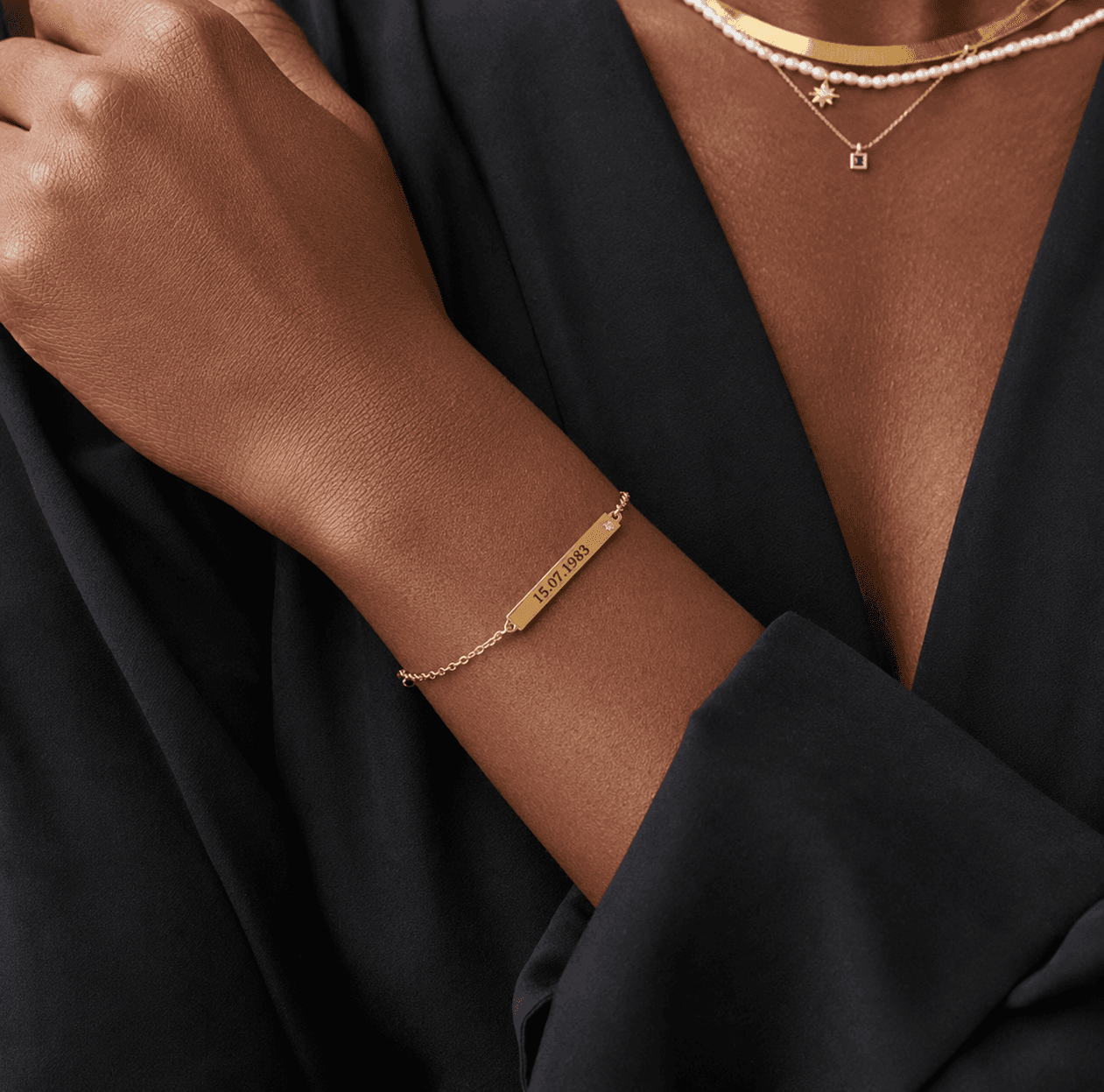 Close view of a woman wearing the Gold ID Name Bracelet with Diamond